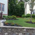 natural stone retaining wall by riverfront landscape | full service landscape company